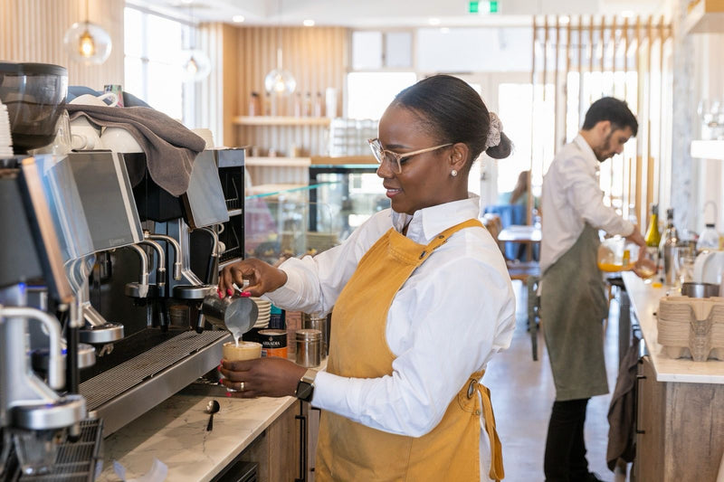 L'Anse French Café team member at the coffee machine